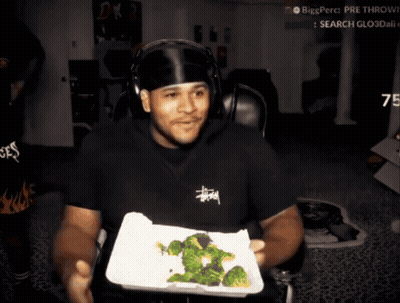 Man In Stussy Shirt Holding Tray Of Broccoli GIF