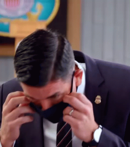Man In Suit Adjusting Face Mask GIF
