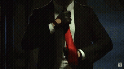 Man In Suit Adjusting Red Tie GIF