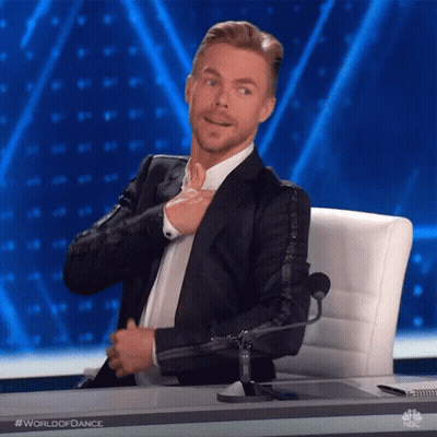 Man In Suit Adjusting Tie At Microphone GIF
