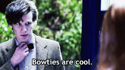 Man In Suit Adjusts Bow Tie Woman Says Bowties Are Cool GIF