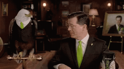 Man In Suit And Bald Eagle In Green Tie GIF