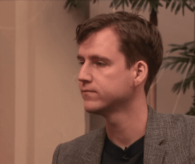 Man In Suit And Black Shirt Looking To Side GIF