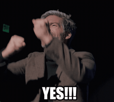 Man In Suit And Black Turtleneck Giving Yes Sign GIF