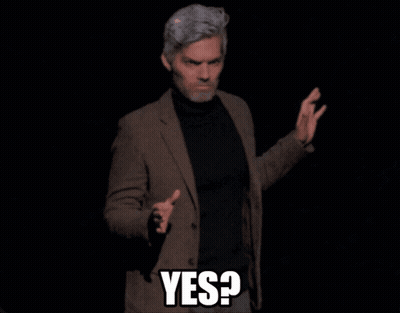Man in Suit and Black Turtleneck Saying Yes