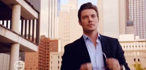 Man In Suit And Blue Shirt In City GIF