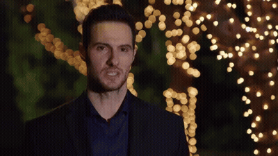 Man In Suit And Blue Shirt In Front Of Christmas Tree GIF