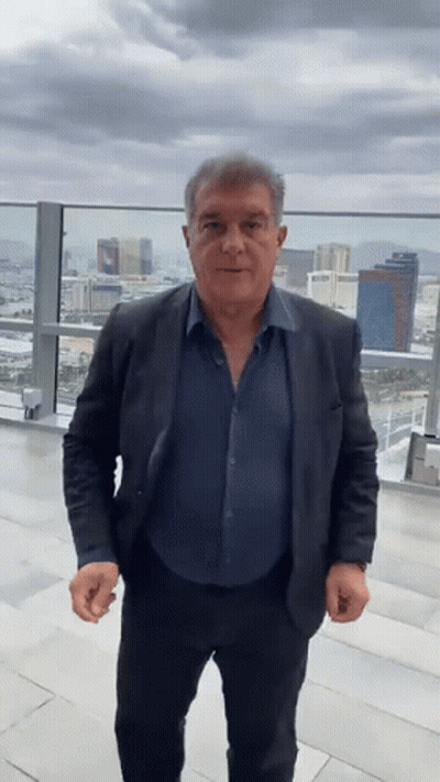 Man In Suit And Blue Shirt On Balcony GIF