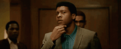 Man In Suit And Blue Shirt Standing With Others GIF