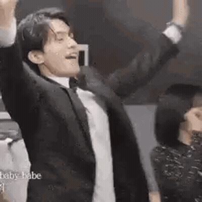 Man In Suit And Bow Tie Dancing Arms Up GIF