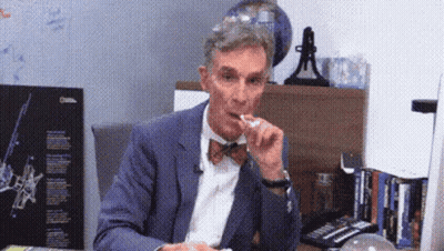 Man in Suit and Bow Tie Eating Food