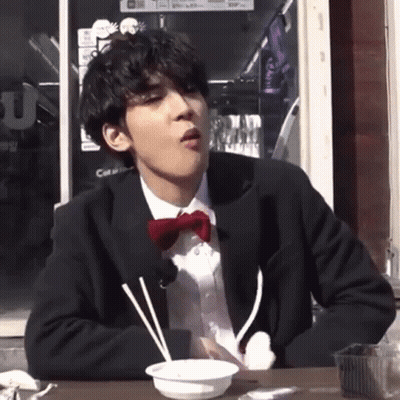 Man In Suit And Bow Tie Eating GIF