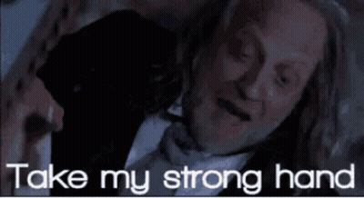 Man In Suit And Bow Tie Laying Down Saying Take My Strong Hand GIF