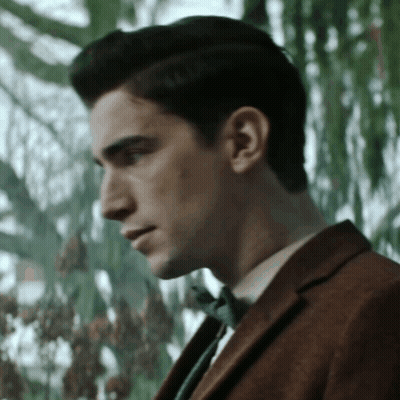 Man In Suit And Bow Tie Looking Down GIF
