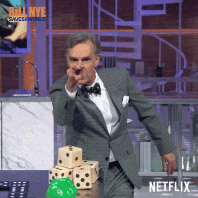 Man In Suit And Bow Tie Pointing At Dice Stack Netflix Logo GIF