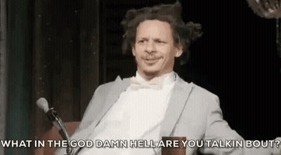Man In Suit And Bow Tie Talking Into Microphone GIF