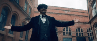 Man In Suit And Bow Tie With Arms Outstretched GIF