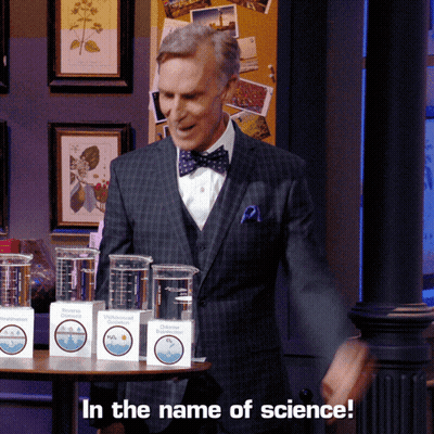 Man In Suit And Bow Tie With In The Name Of Science Boxes GIF