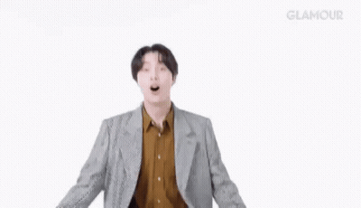 Man in Suit and Brown Shirt Dancing Arms Outstretched