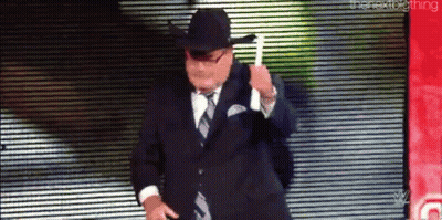 Man In Suit And Cowboy Hat Dancing On Stage GIF