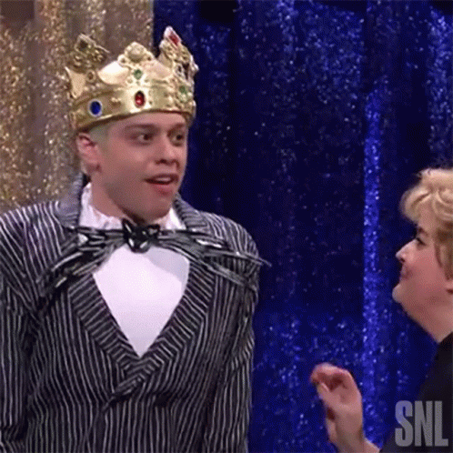 Man In Suit And Crown Next To Woman GIF
