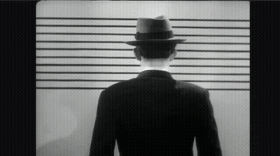 Man In Suit And Fedora In Police Lineup GIF