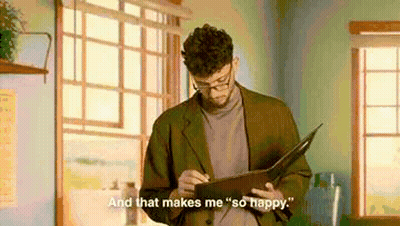 Man In Suit And Glasses Holding Book Says And That Makes Me So Happy GIF