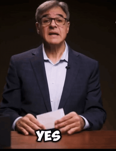 Man In Suit And Glasses Holding Paper Saying Yes GIF