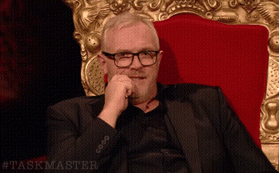 Man In Suit And Glasses In Red Chair Taskmaster GIF