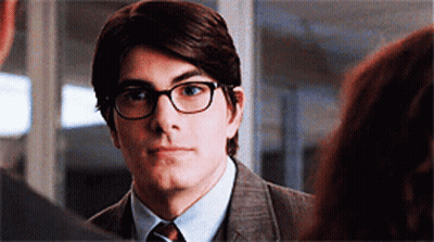 Man In Suit And Glasses Looking At Another GIF