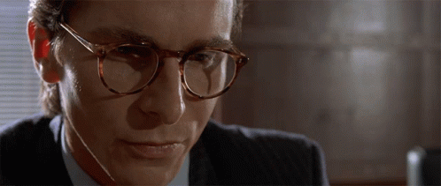 Man In Suit And Glasses Looking Down GIF