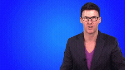 Man In Suit And Glasses Making Hand Gesture GIF