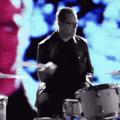 Man In Suit And Glasses Playing Drums GIF