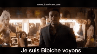 Man In Suit And Glasses Standing Before Women GIF
