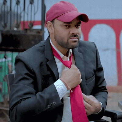 Man In Suit And Hat Adjusting Red Tie GIF