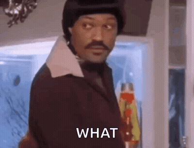Man In Suit And Hat Asking What In Front Of Refrigerator GIF