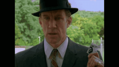 Man In Suit And Hat Holding Card With Face GIF