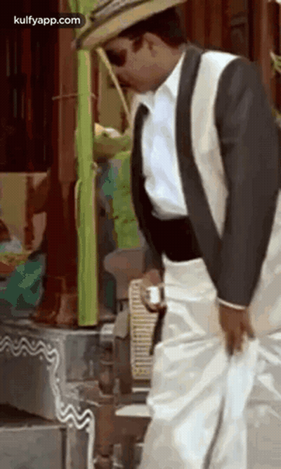 Man In Suit And Hat Holding Coffee GIF