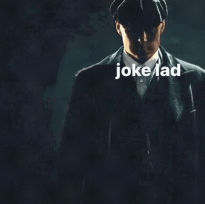 Man In Suit And Hat In Dark With Jokelad GIF