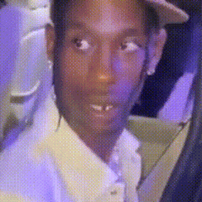 Man In Suit And Hat Looking At Camera On Purple Background GIF