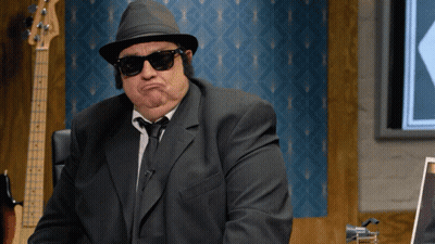 Man In Suit And Hat Making A Face GIF