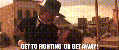 Man In Suit And Hat Says Get To Fighting Or Get Away GIF