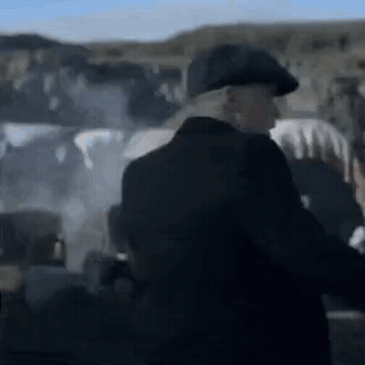 Man In Suit And Hat Standing Before Group GIF