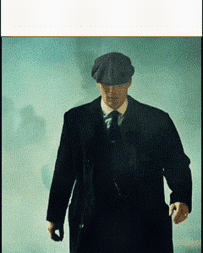 Man In Suit And Hat Walking In Foggy Room GIF