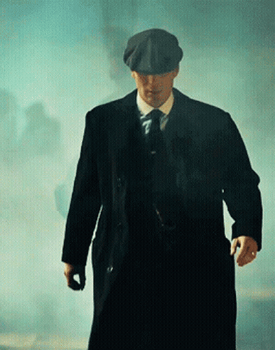 Man In Suit And Hat Walking Through Fog GIF