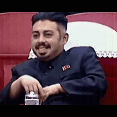 Man In Suit And Orange Tie Making A Face GIF