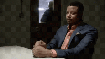 Man In Suit And Pink Shirt At Table GIF