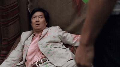 Man In Suit And Pink Shirt Lying Down GIF