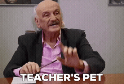 Man In Suit And Pink Shirt Says Teacher's Pet GIF