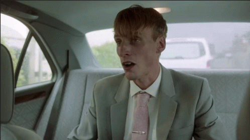 Man In Suit And Pink Tie Sitting In Car GIF